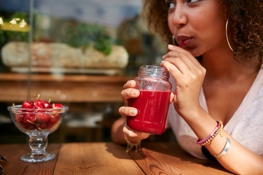Young woman having fresh fruit juice