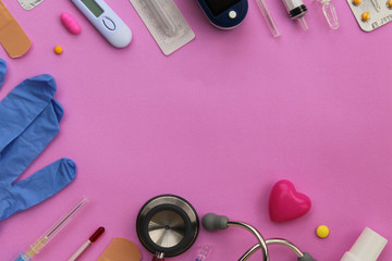Obraz na płótnie Canvas Medicine concept - pill, bottle, tablet, syringe, needle, ampule, glove, bandage, stethoscope, pulse meter, thermometer and heart - copy space on pink background