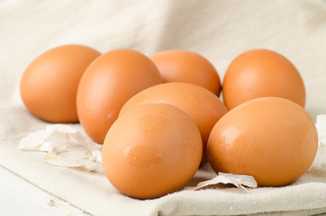 Fresh eggs on fabric background