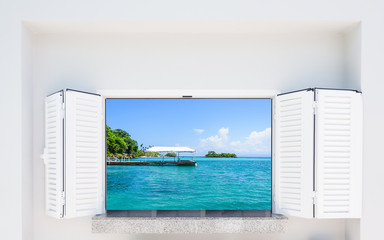 window with shutters overlooking the sea