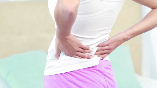 Rear view of woman with back pain