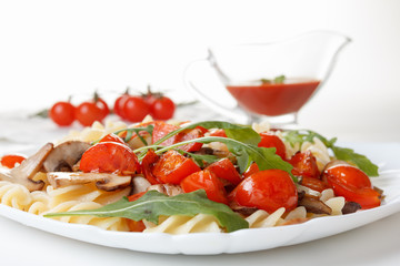 Pasta with mushrooms, cherry tomatoes and tomato sauce, italian food. Closeup