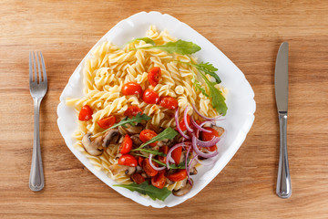 Pasta with mushrooms, cherry tomatoes and tomato sauce, italian food. Closeup