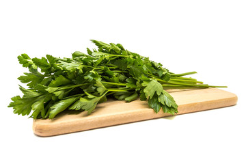 Parsley on a wooden board isolated on white background