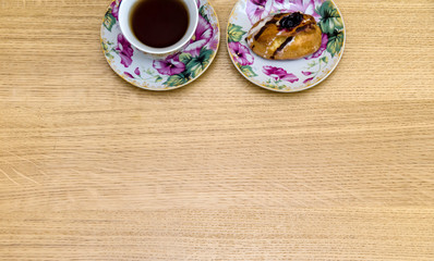 Hot Cup of Black Tea with cake on Wooden Tabletop. Top View