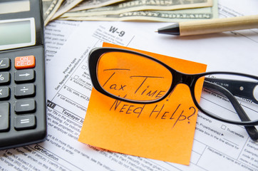 W-9 tax form as a business concept with pen, calculator and sticker