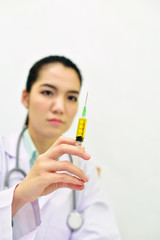 Asian female doctor with syringe
