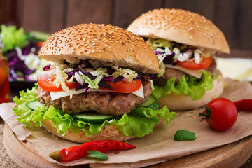 Sandwich hamburger with juicy burgers, cheese and mix of cabbage