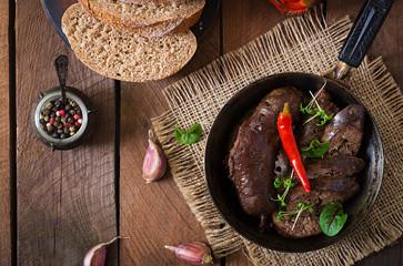 Homemade blood sausage with offal on the old wooden background in rustic style. Top view