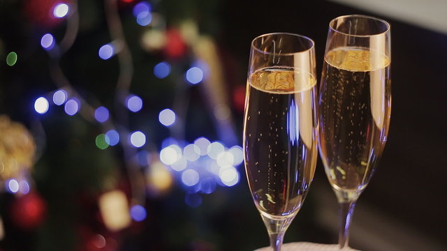 pair of champagne glasses, Christmas tree ornament as the background