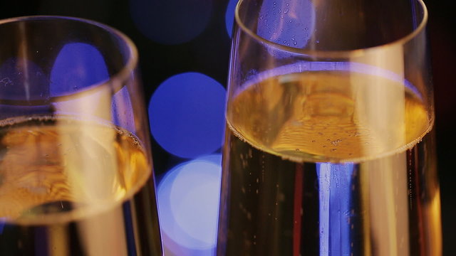 Champagne in glasses on a background of the Christmas tree and lights