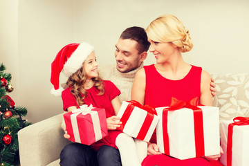 smiling family holding many gift boxes