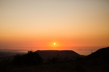 sunset silhouette with sea in background
