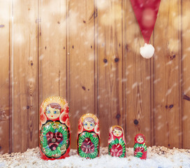 set of matryoshka covered by christmas hat warm look filtered