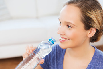 happy woman with water bottle at home