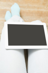 Close up digitabl tablet and woman hands, at home sitting on sofa