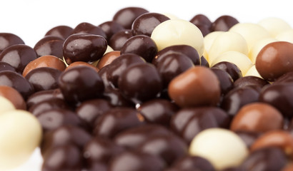 small chocolate balls closeup on a white background
