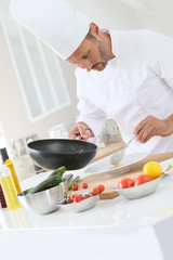 Chef cooking in dosmetic kitchen