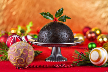 Christmas pudding on a decorated red table