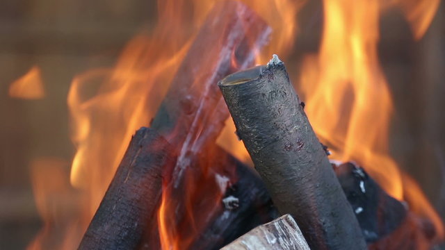 Close up of burning wood in a fire pit in slow motion (50% speed).