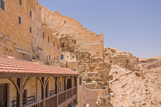 Outside wall of Great Lavra (monastery) of St. Sabbas the Sanctified (Mar Saba) with terrace on slope of Kidron river canyon. Judean desert, Palestine, Israel. 

