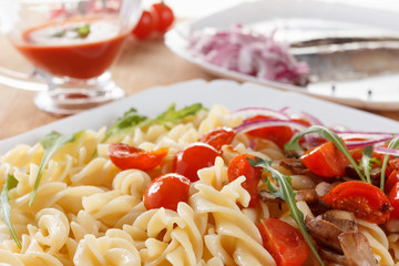 Pasta with mushrooms, cherry tomatoes and tomato sauce, italian food. Closeup