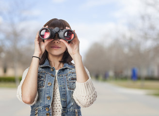 portrait of a pretty young woman looking through the binoculars