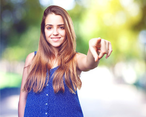 young woman pointing front on white background