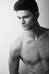 Fototapeta premium Handsome naked torso gy model studio portrait