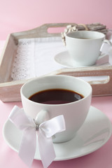 Coffee cups with ribbon on the handle