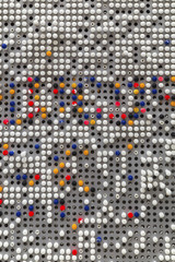 Background of colorful plastic knobs on metal plate