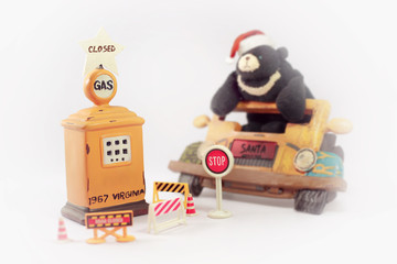 Bear wearing a Christmas Santa hat with retro Gasoline pump.Sant