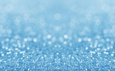 Blue defocused glitter background.