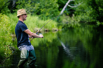 Young Fisherman Catching a big Fish