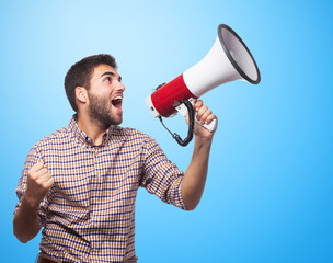 portrait of a handsome man shouting with a megaphone