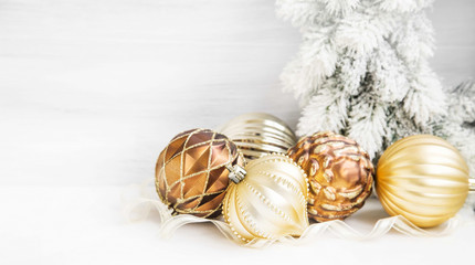 Fototapeta na wymiar Golden Christmas tree ornaments with delicate pearly balls decor