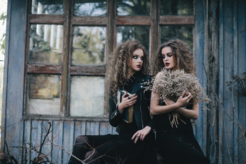 Two vintage witches gathered eve of Halloween
