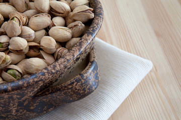 pistachios in a ceramic bowl on the table