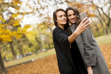 Young women taking selfie with smartphone outdoor