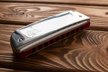 harmonica on wooden background closeup