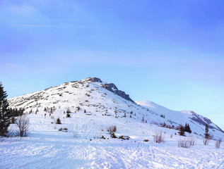 Beautiful winter landscape in high mountains with hill