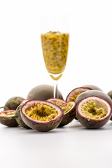 Halved Passionfruits And Fruit Pulp In A Glass