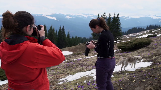 two female photographers practicing in mountains