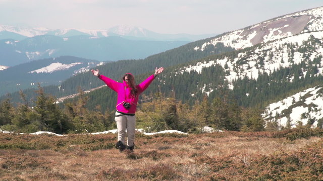  female hiker posing for photo in mountains slow motion