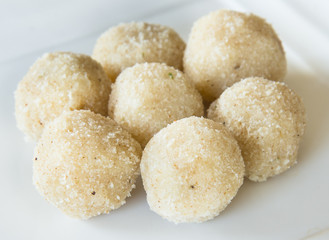 Fototapeta na wymiar Coconut laddu, a famous Indian sweet with almonds and pistachio