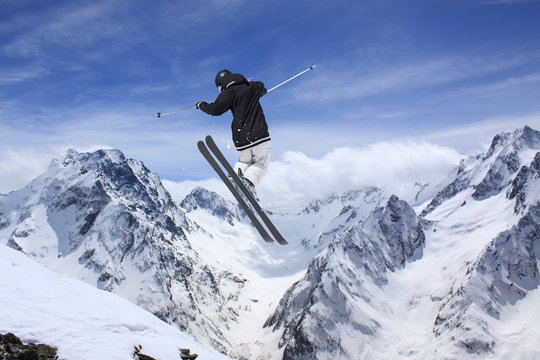 Flying skier on mountains. Extreme sport.