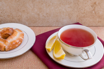 Breakfast with pastries, and hot tea with lemon.