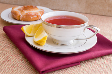 Breakfast with pastries, and hot tea with lemon.