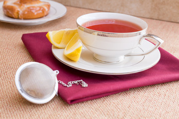 Breakfast with pastries, and hot tea with lemon.