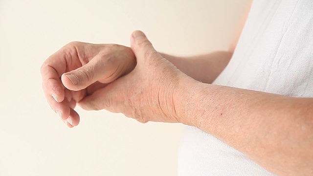 a man suffering from pain in his thumb